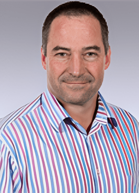 Man in striped shirt, neutral background.